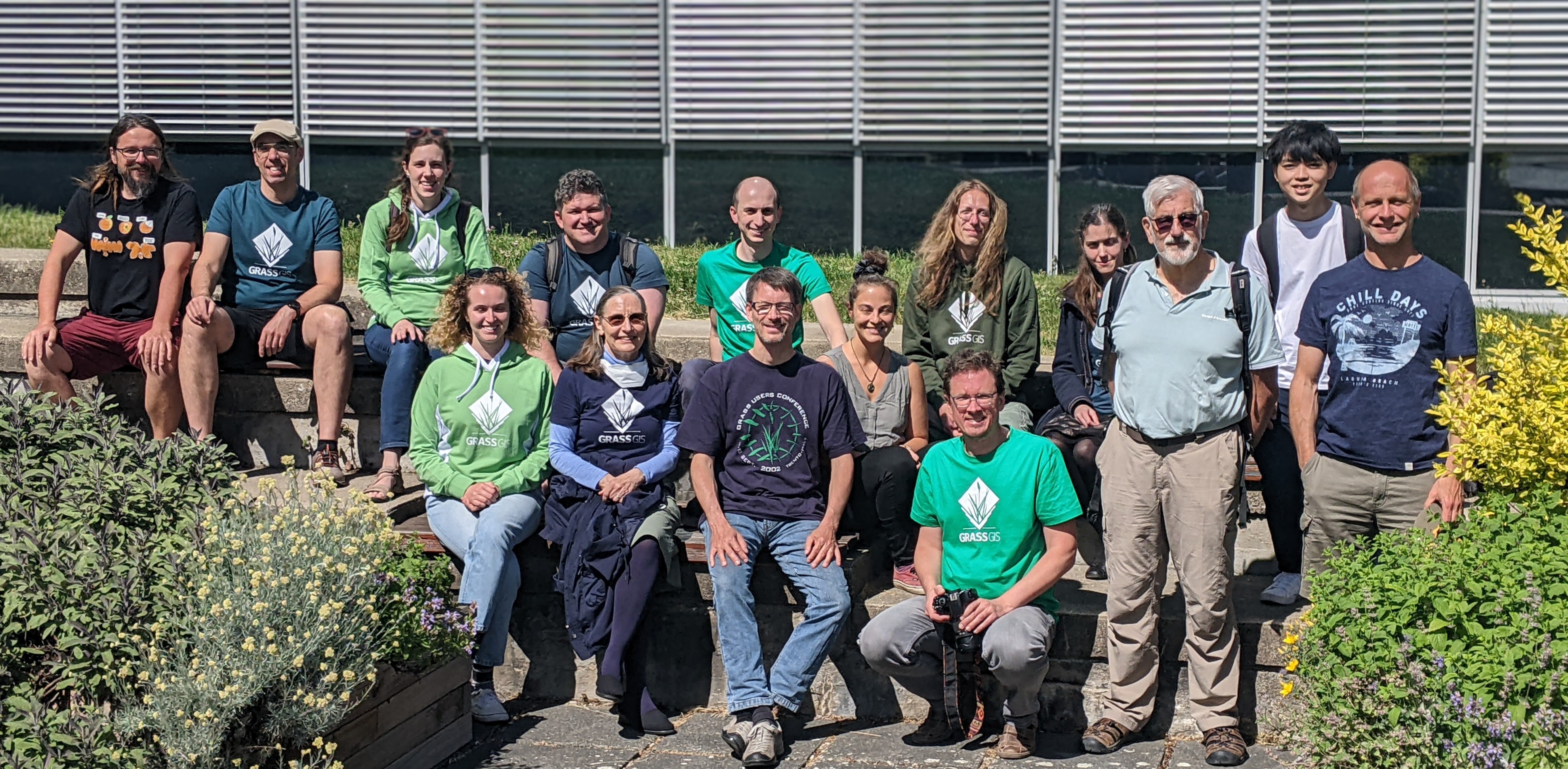 Group of smiling people in GRASS GIS t-shirts